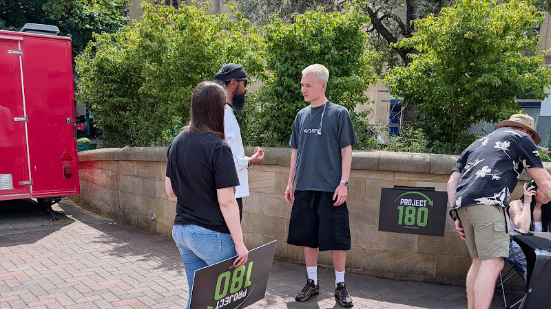 A Project 180 volunteer speaks with a participant after he completed the Movie Challenge in Bedford.