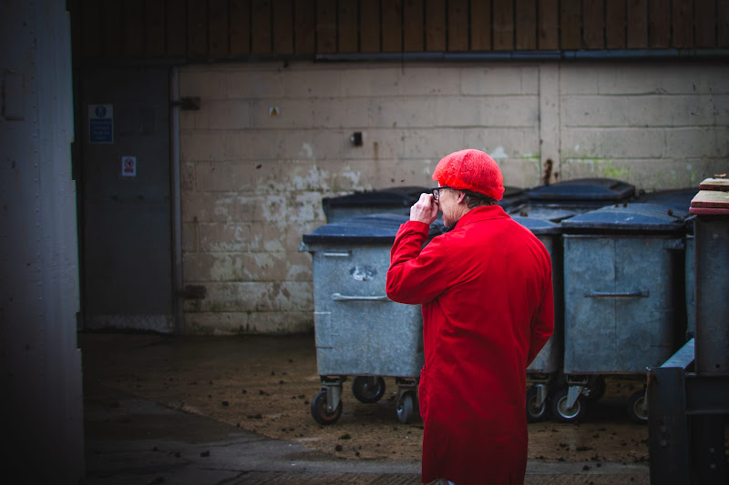 Slaughterhouse worker picking nose