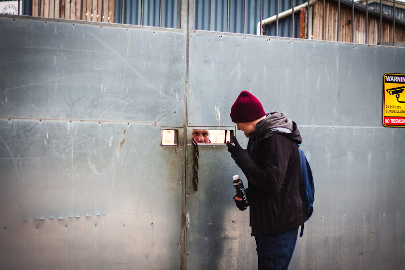 Activist speaking with security at slaughterhouse