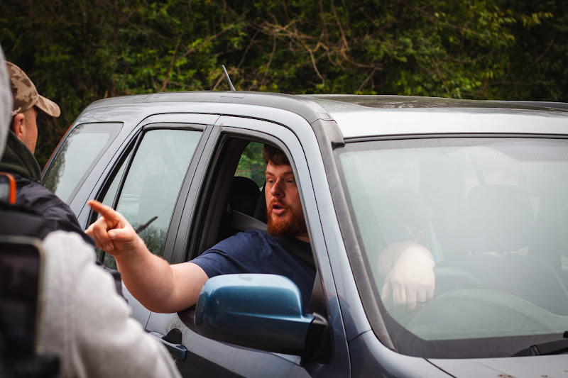 Activist speaking with driver at slaughterhouse