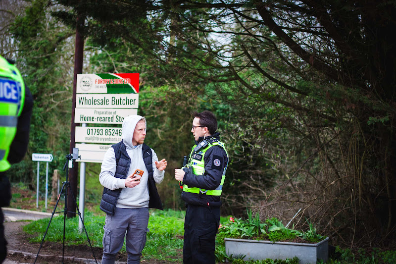 Activist speaking with police at slaughterhouse