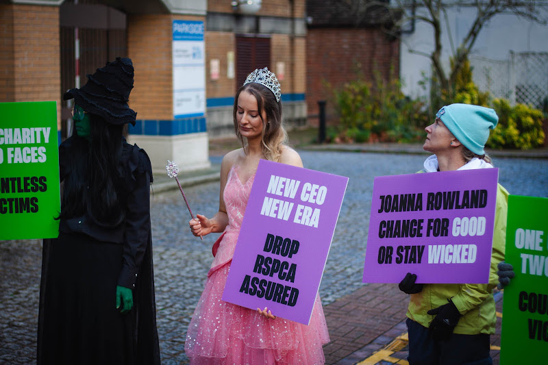 Protestors holding placards: Drop RSPCA Assured